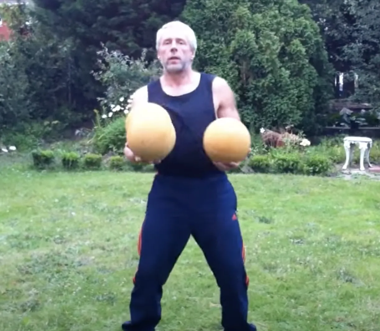 man juggling heavy juggling balls