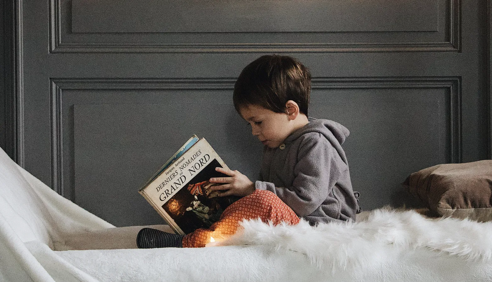 child reading a book on magic